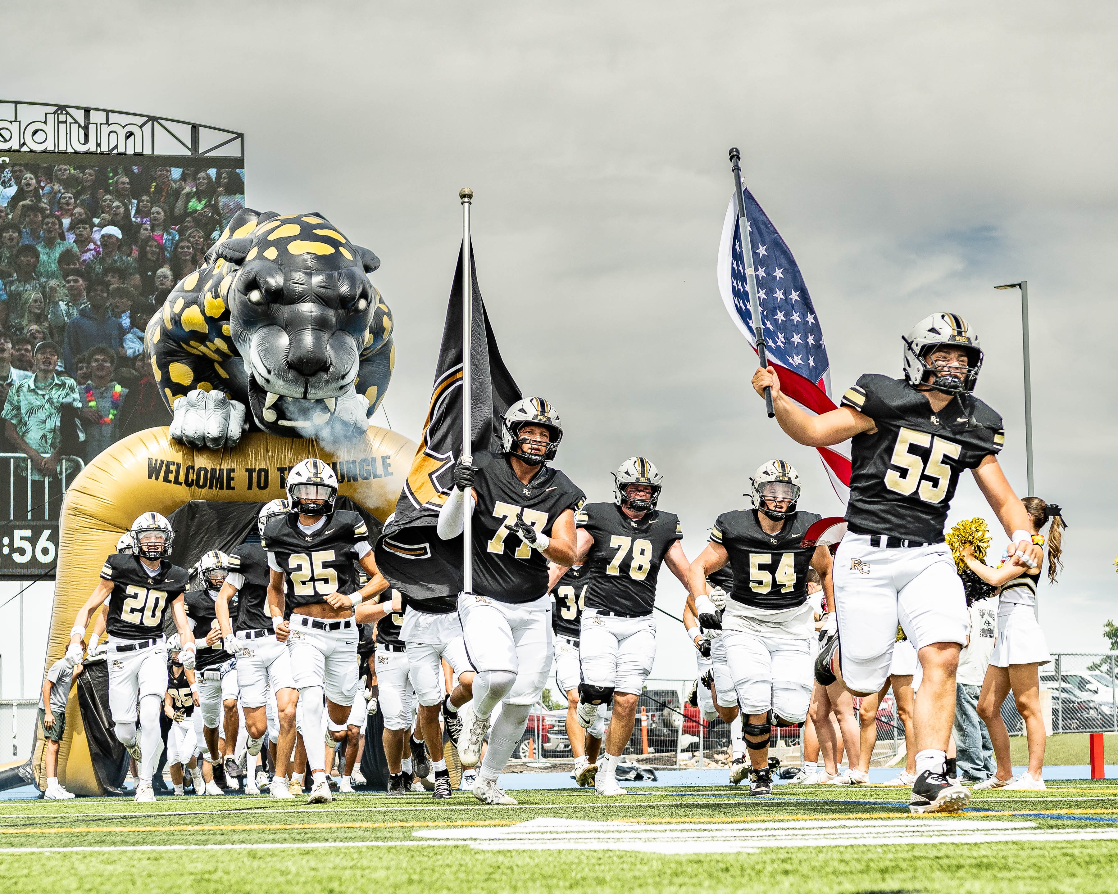 Rock Canyon Jaguars football players running onto the field before a game